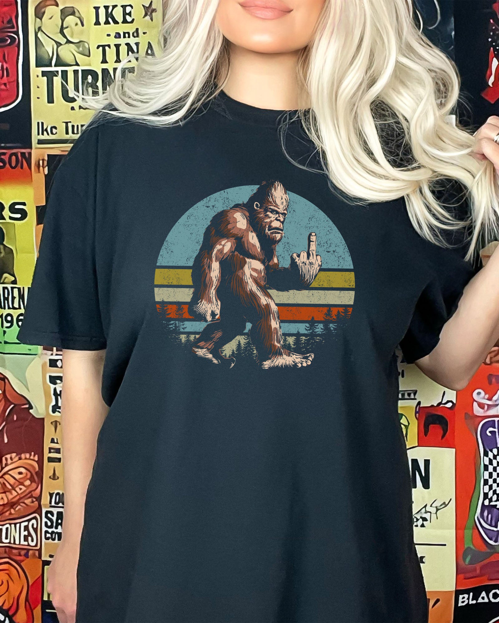 Woman wearing black color shirt with funny retro Bigfoot showing middle finger graphic