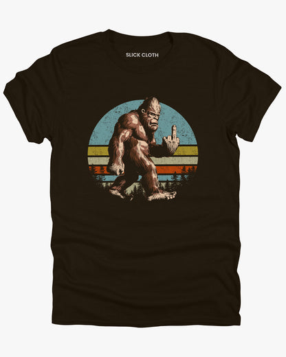 Flat lay dark chocolate color tee with funny vintage Bigfoot showing middle finger graphic