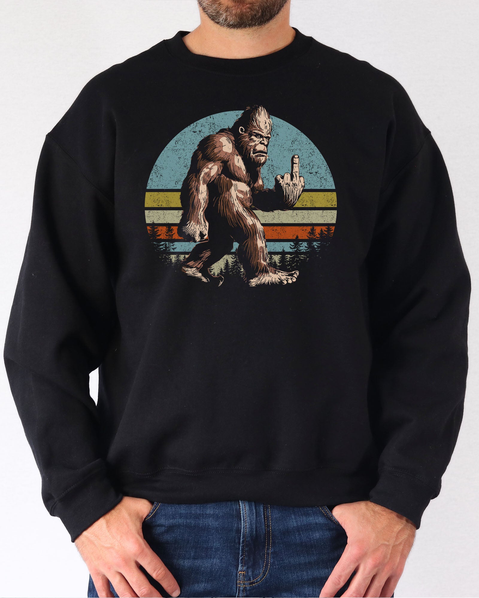 Man wearing a black sweatshirt featuring a funny retro-style Bigfoot showing the middle finger graphic.
