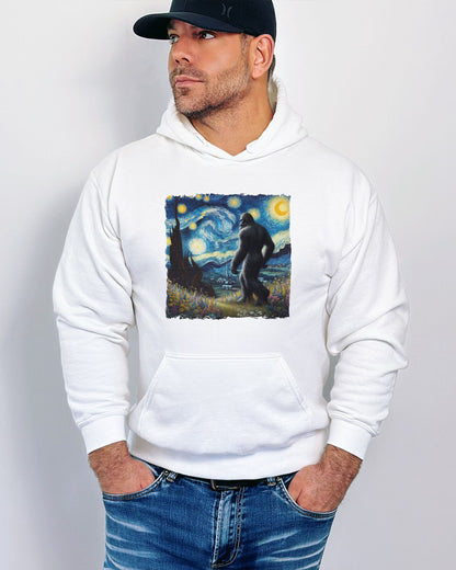 Man wearing a white hoodie featuring a Bigfoot walking through a starry night forest graphic.