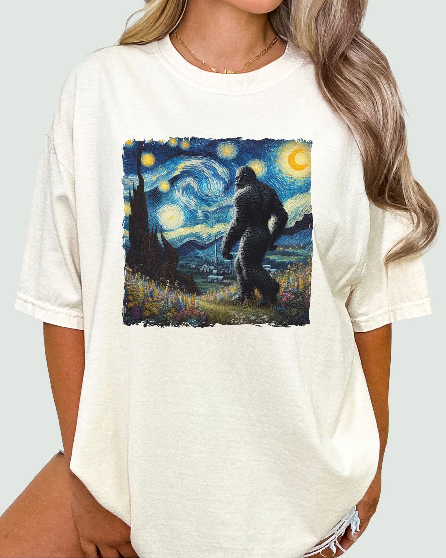 Bigfoot Starry Night shirt in natural beige worn by a woman, featuring a retro Bigfoot walking through a Starry Night-inspired graphic design by Vincent Van Gogh, unisex fit.