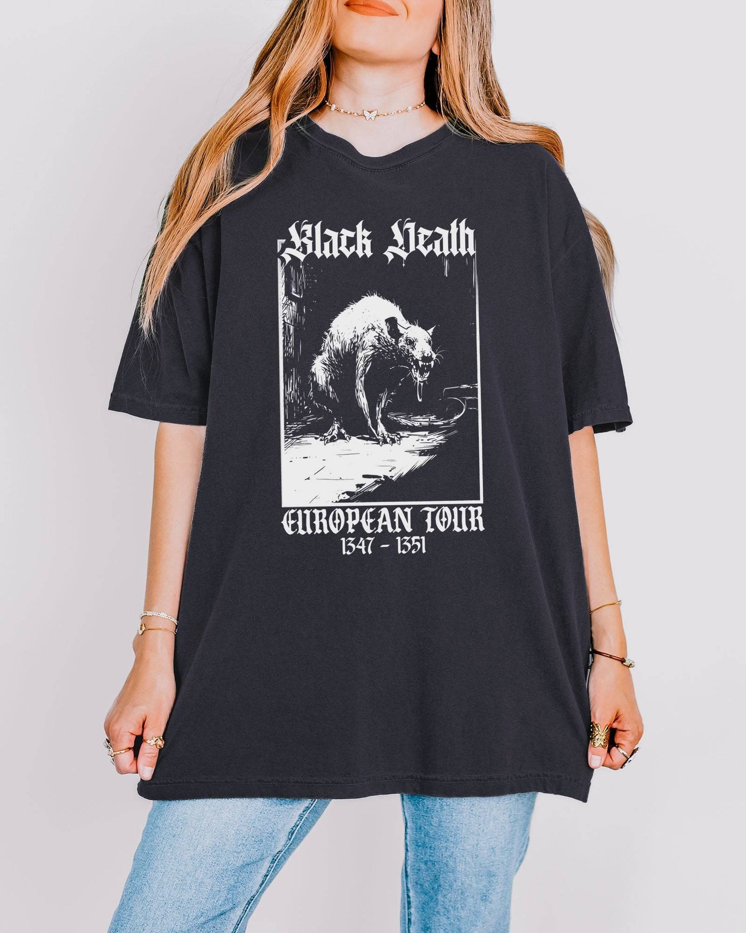 Woman wearing a graphite-colored 'Black Death European Tour 1347–1351' shirt with a retro graphic of a medieval plague rat.