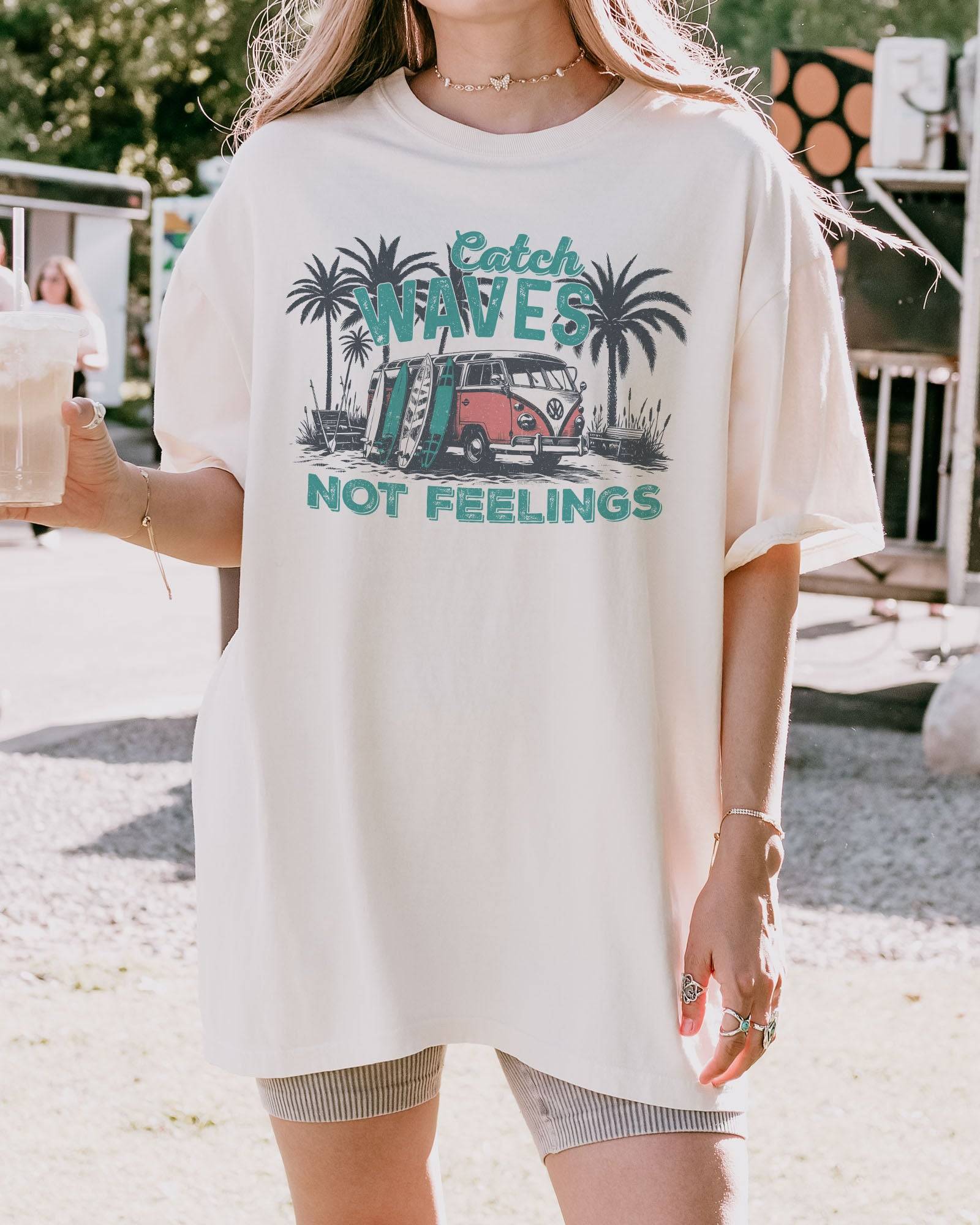 Model wearing ivory color shirt with 'Catch Waves Not Feelings' summer graphic design