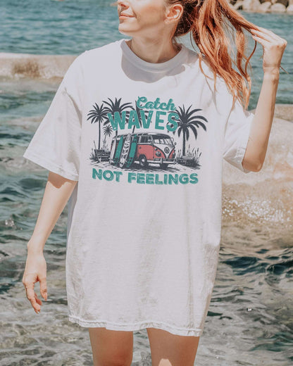 Model wearing white color shirt with 'Catch Waves Not Feelings' summer graphic design