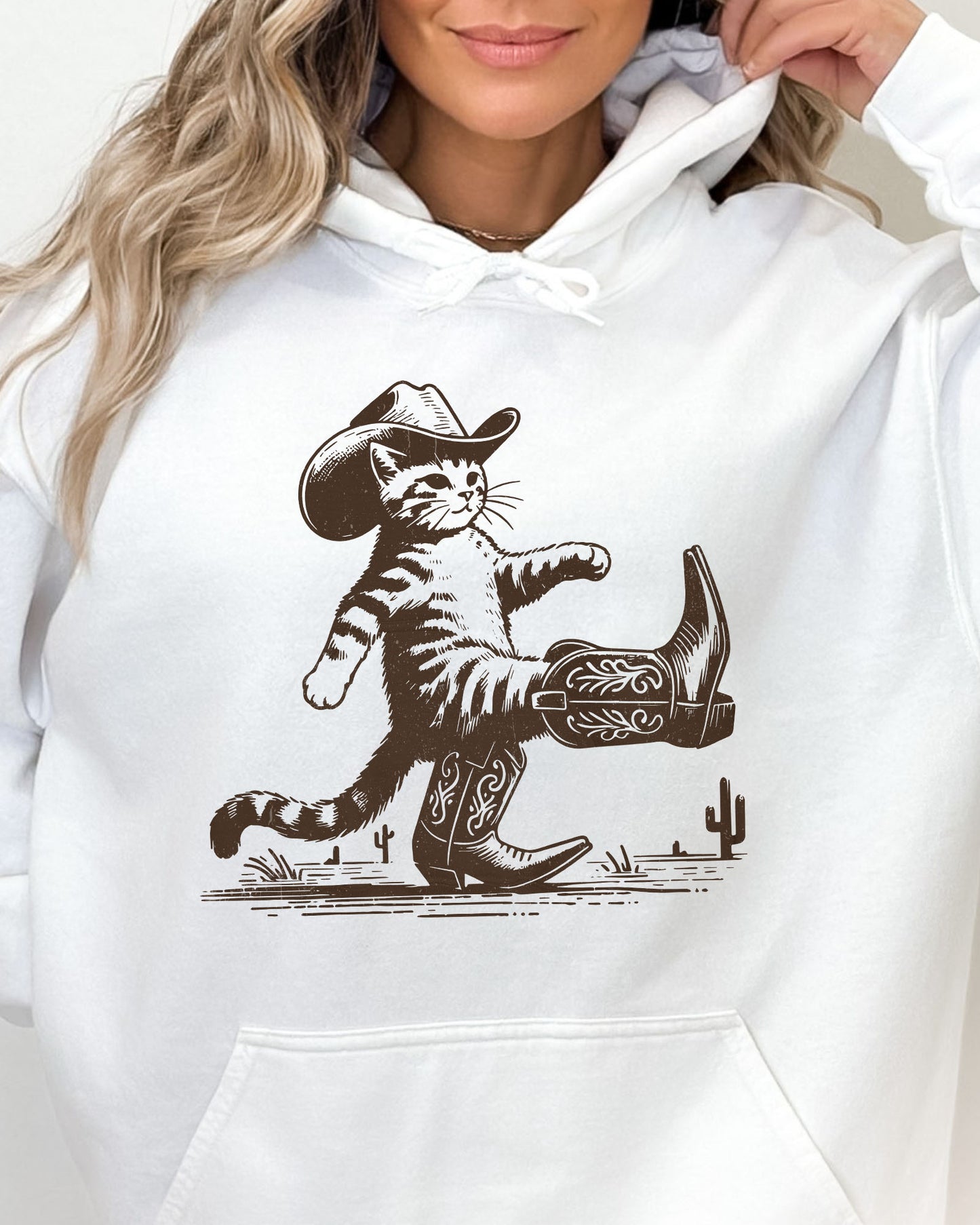 Close-up of a white hoodie featuring a retro-style cowboy cat graphic with a funny Western theme.