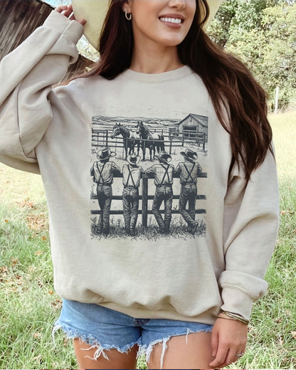 Model wearing sand color sweatshirt with 'Cowboy Gang' graphic design