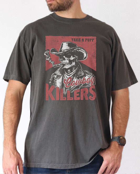 Man wearing pepper color shirt with 'Cowboy Killers' funny smoking skeleton graphic design