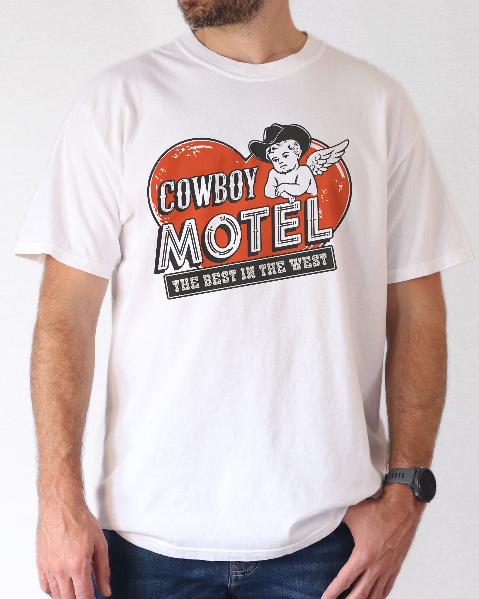 Model wearing white color shirt with 'Cowboy Motel - The Best In The West' Valentine's Day graphic design