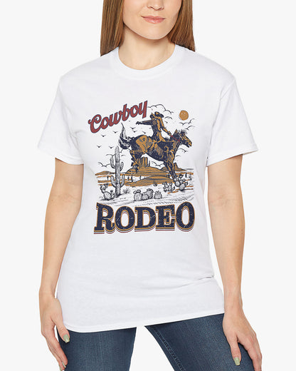 Woman wearing a white Cowboy Rodeo graphic t-shirt featuring a retro Western design, standing outdoors.