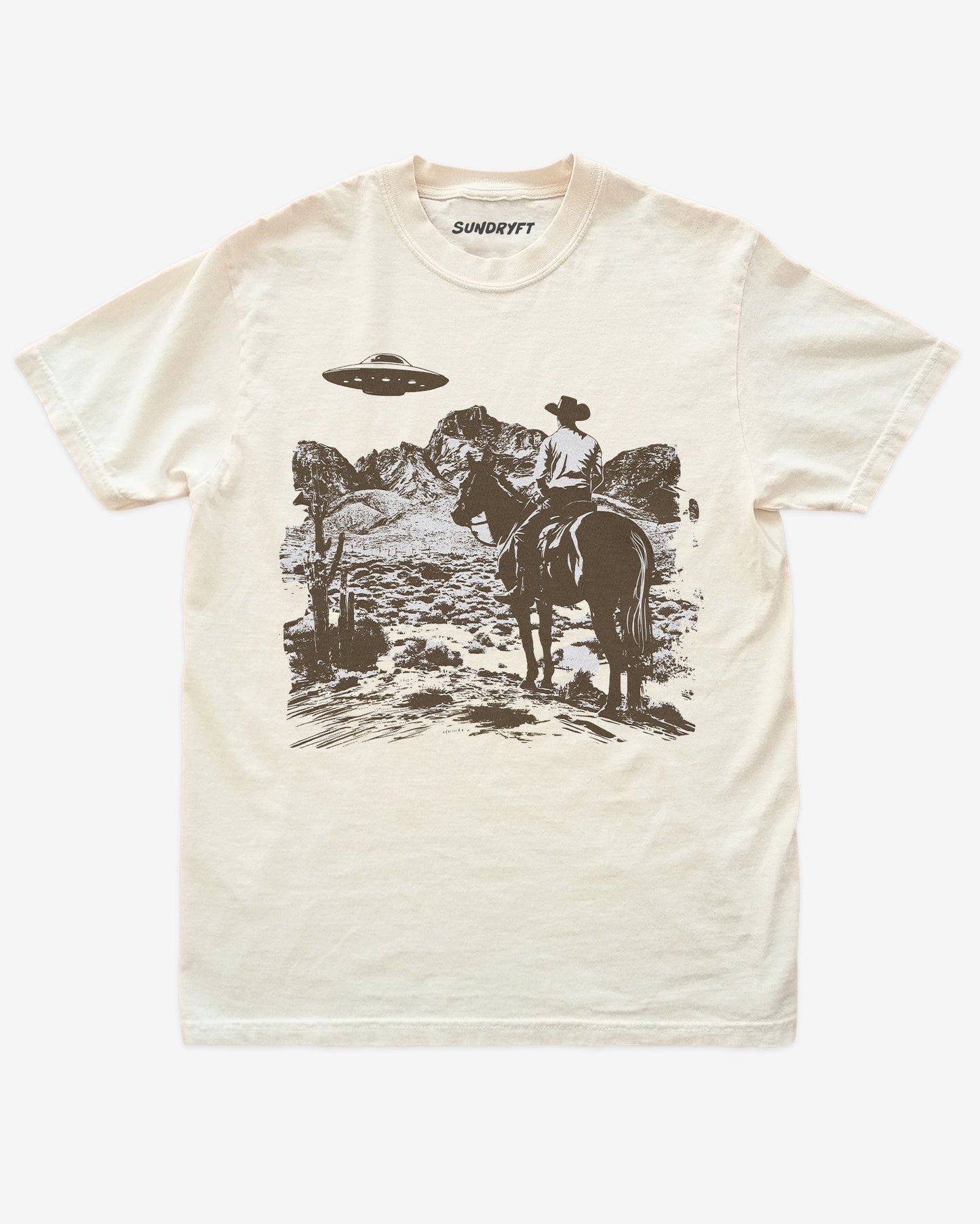 Ivory “Cowboy UFO” shirt with cowboy riding horse through desert under UFO graphic flat lay.
