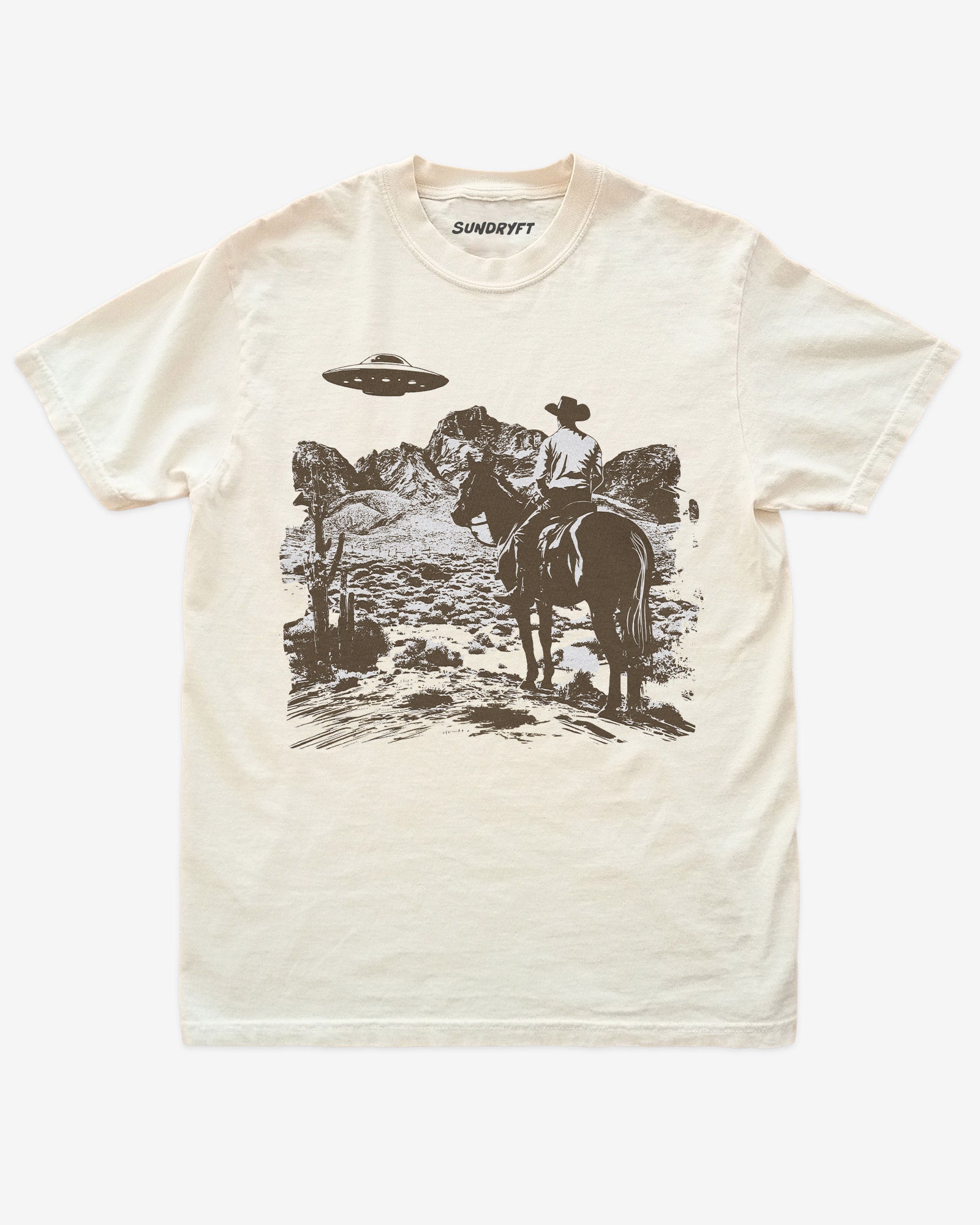 Ivory “Cowboy UFO” shirt with cowboy riding horse through desert under UFO graphic flat lay.