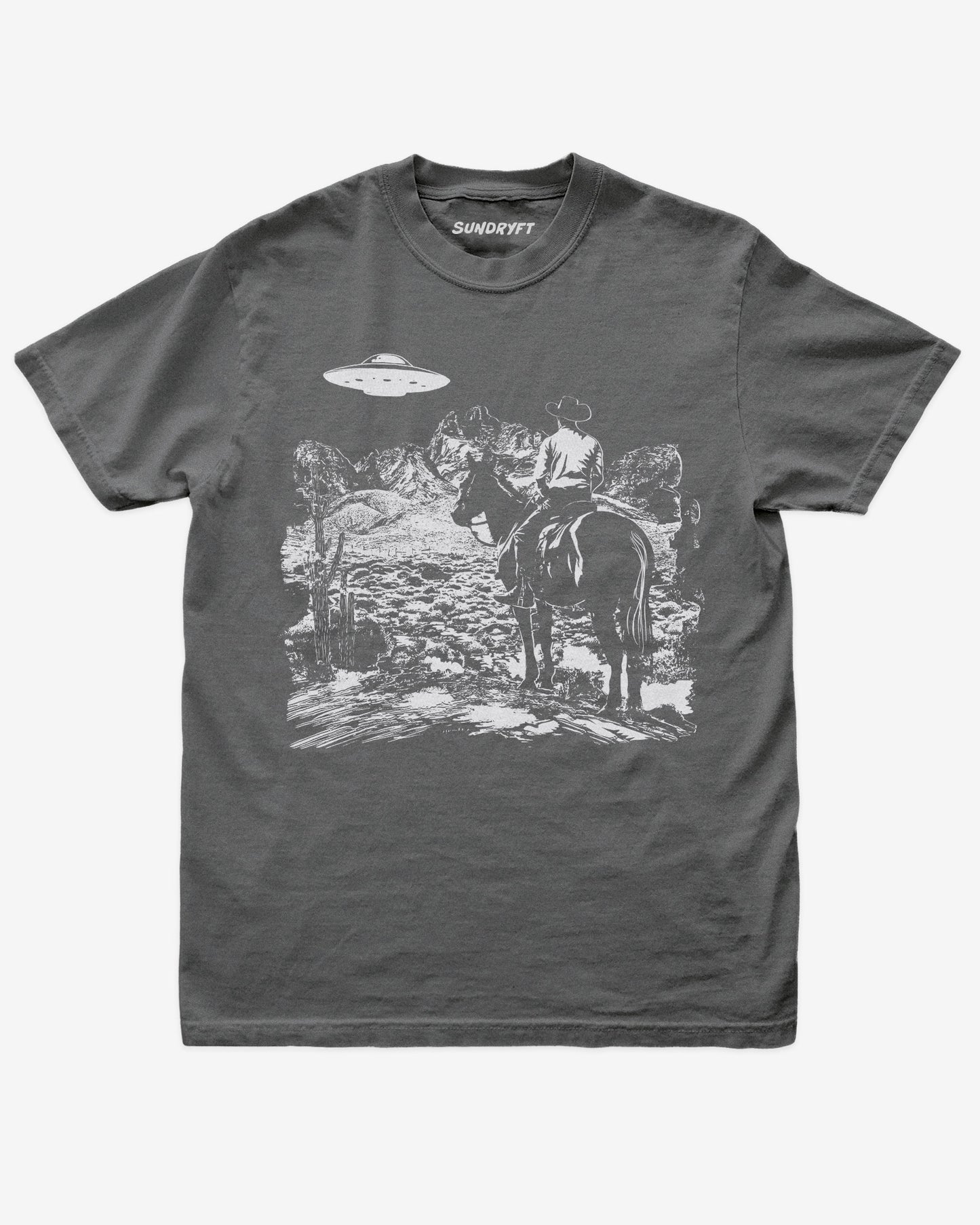 Pepper “Cowboy UFO” shirt with cowboy riding horse through desert under UFO graphic flat lay.