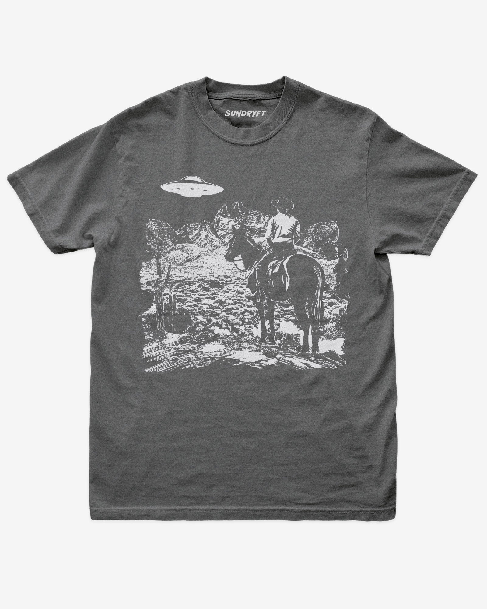Pepper “Cowboy UFO” shirt with cowboy riding horse through desert under UFO graphic flat lay.