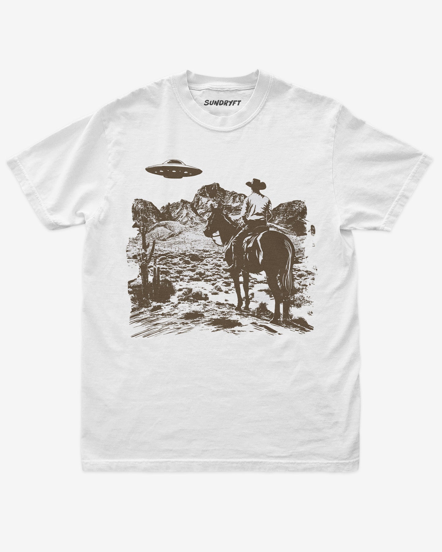 White “Cowboy UFO” shirt with cowboy riding horse through desert under UFO graphic flat lay.