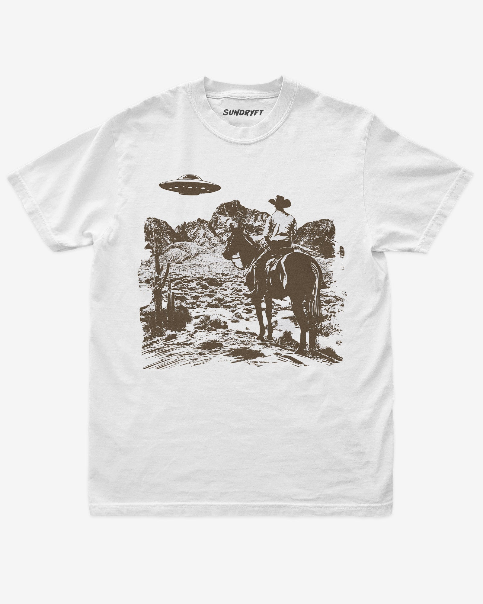 White “Cowboy UFO” shirt with cowboy riding horse through desert under UFO graphic flat lay.