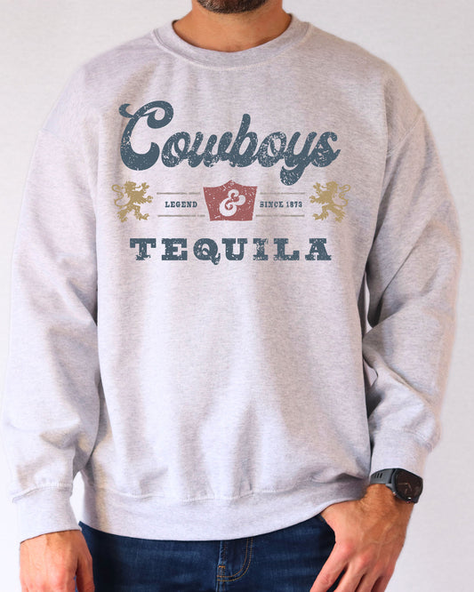 Man wearing an ash gray sweatshirt featuring a retro 'Cowboys And Tequila' graphic.