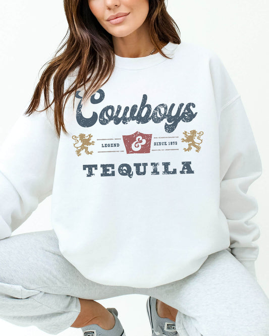 Woman wearing a white sweatshirt featuring a retro 'Cowboys And Tequila' graphic.