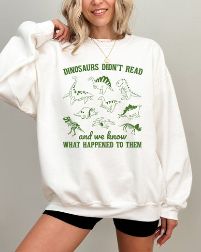 Model wearing white color sweatshirt with 'Dinosaurs Didn't Read And We Know What Happened To Them' graphic design