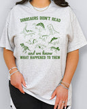 Funny reading motivation shirt in ash grey color with the quote "Dinosaurs didn't read and we know what happened to them"