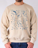 Model wearing sand color sweatshirt with 'Dinosaurs In Space' graphic design