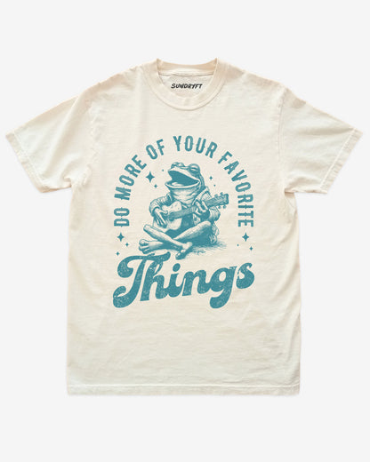Do More Of Your Favorite Things shirt in ivory with frog playing guitar graphic