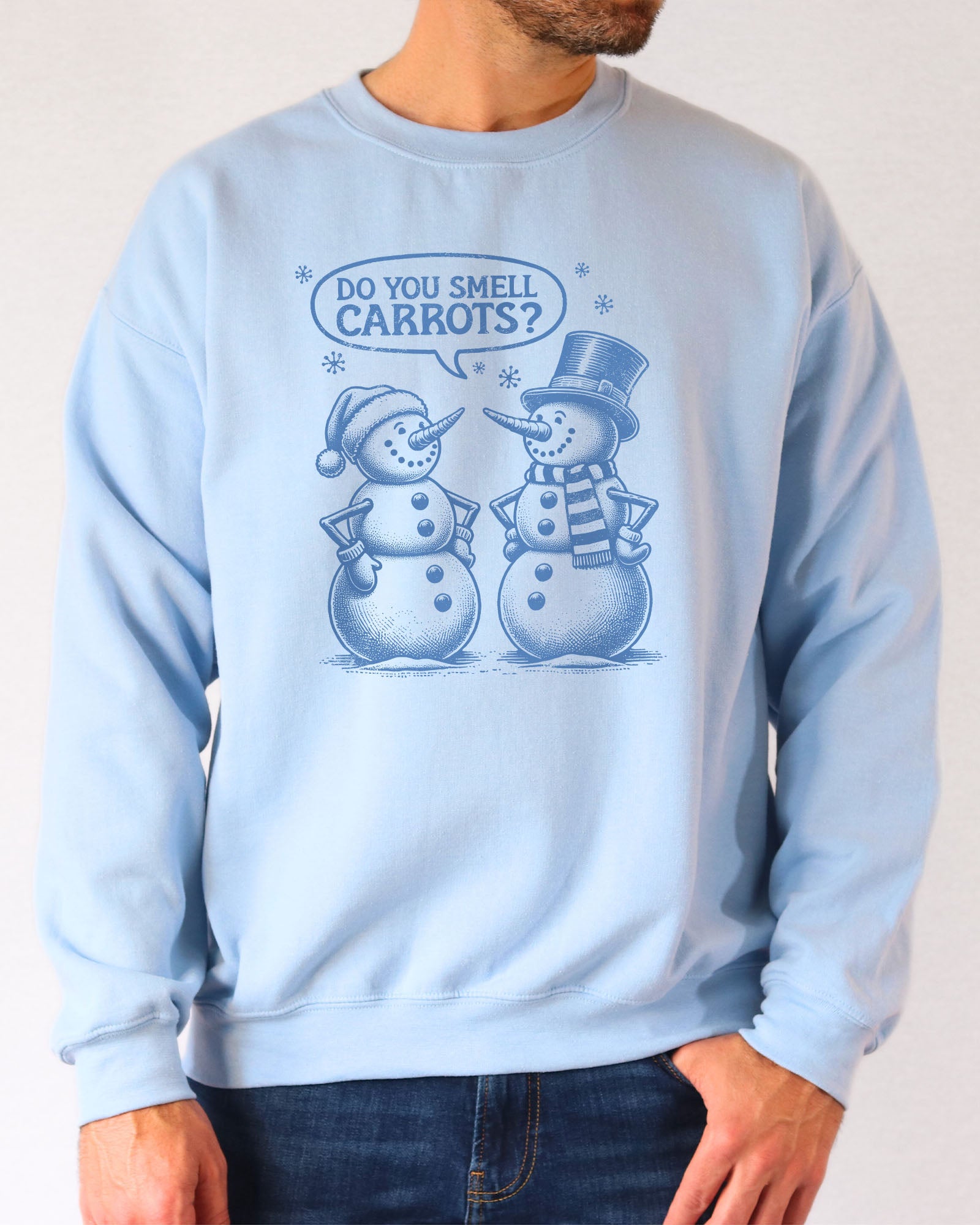 Model wearing light blue color sweatshirt with 'Do You Smell carrots?' snowmen conversation graphic design