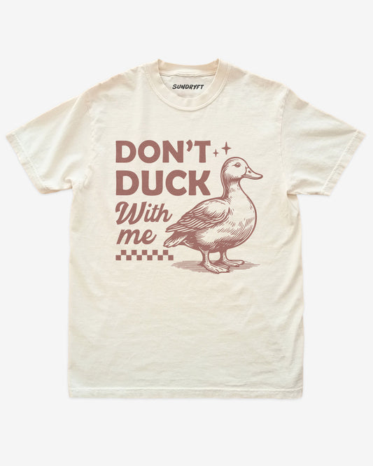Ivory “Don’t Duck With Me” shirt with funny angry duck graphic flat lay.