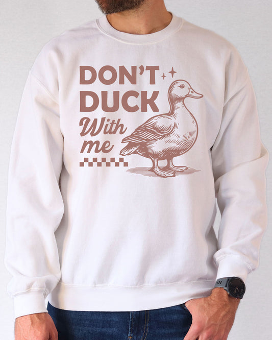 Man wearing a white sweatshirt featuring a funny retro duck graphic and the quote 'Don't Duck With Me'.