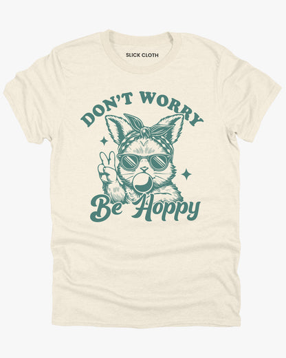 Flat lay natural-colored 'Don't Worry, Be Hoppy' shirt featuring a funny retro easter bunny graphic.