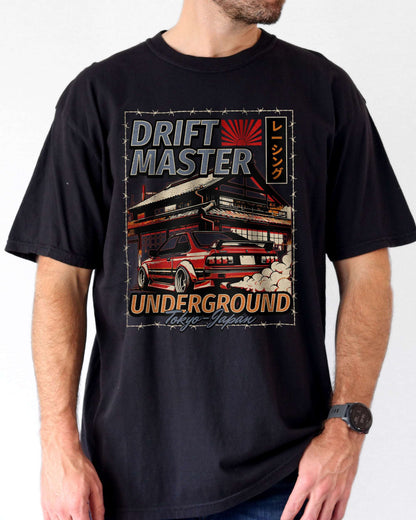 Man wearing a black Drift Master Tokyo shirt with a retro graphic of a race car and Japanese house.