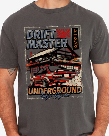 Close-up of man wearing a pepper Drift Master Tokyo shirt with a retro graphic of a race car and Japanese house.