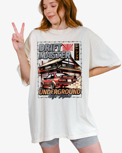 Woman wearing an ivory Drift Master Tokyo shirt with a retro graphic of a race car and Japanese house.