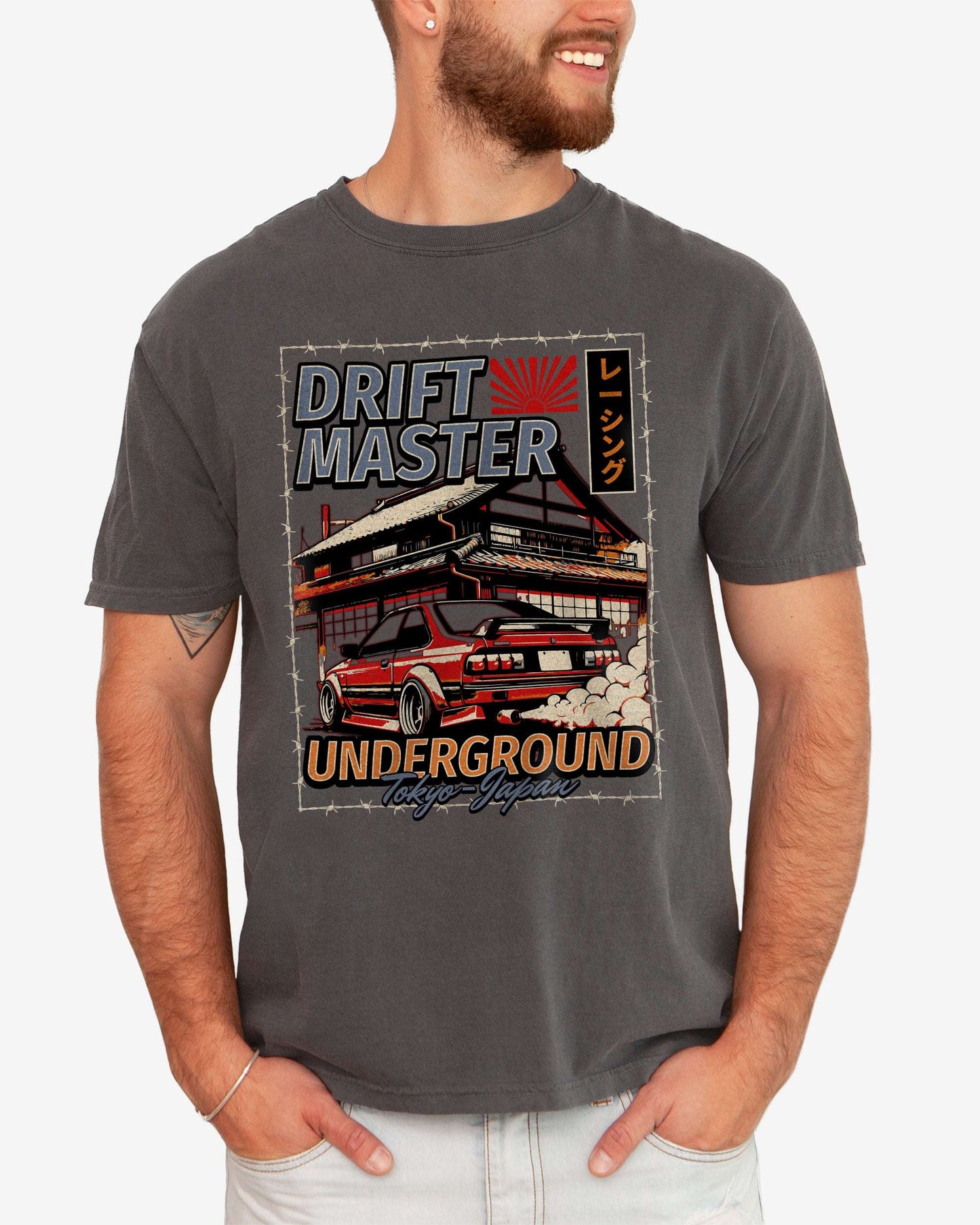 Man wearing a pepper Drift Master Tokyo shirt with a retro graphic of a race car and Japanese house.
