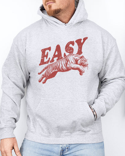 Man wearing an ash-colored 'Easy Tiger' hoodie featuring a vintage-style graphic of a tiger mid-jump.