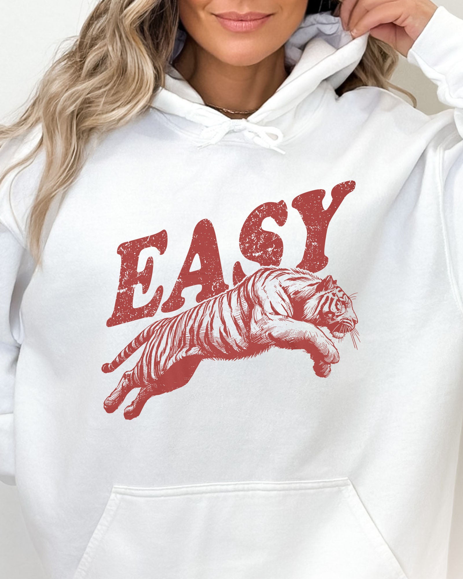 Close-up of a white-colored 'Easy Tiger' hoodie featuring a vintage-style jumping tiger graphic.