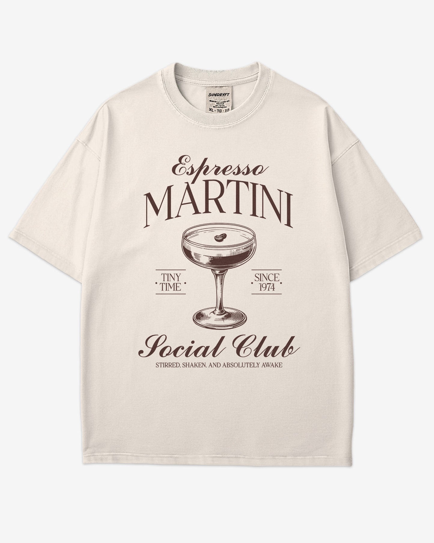 Flat lay ivory 'Espresso Martini Social Club – Stirred, Shaken, and Awake' shirt with a retro graphic of an espresso martini glass.
