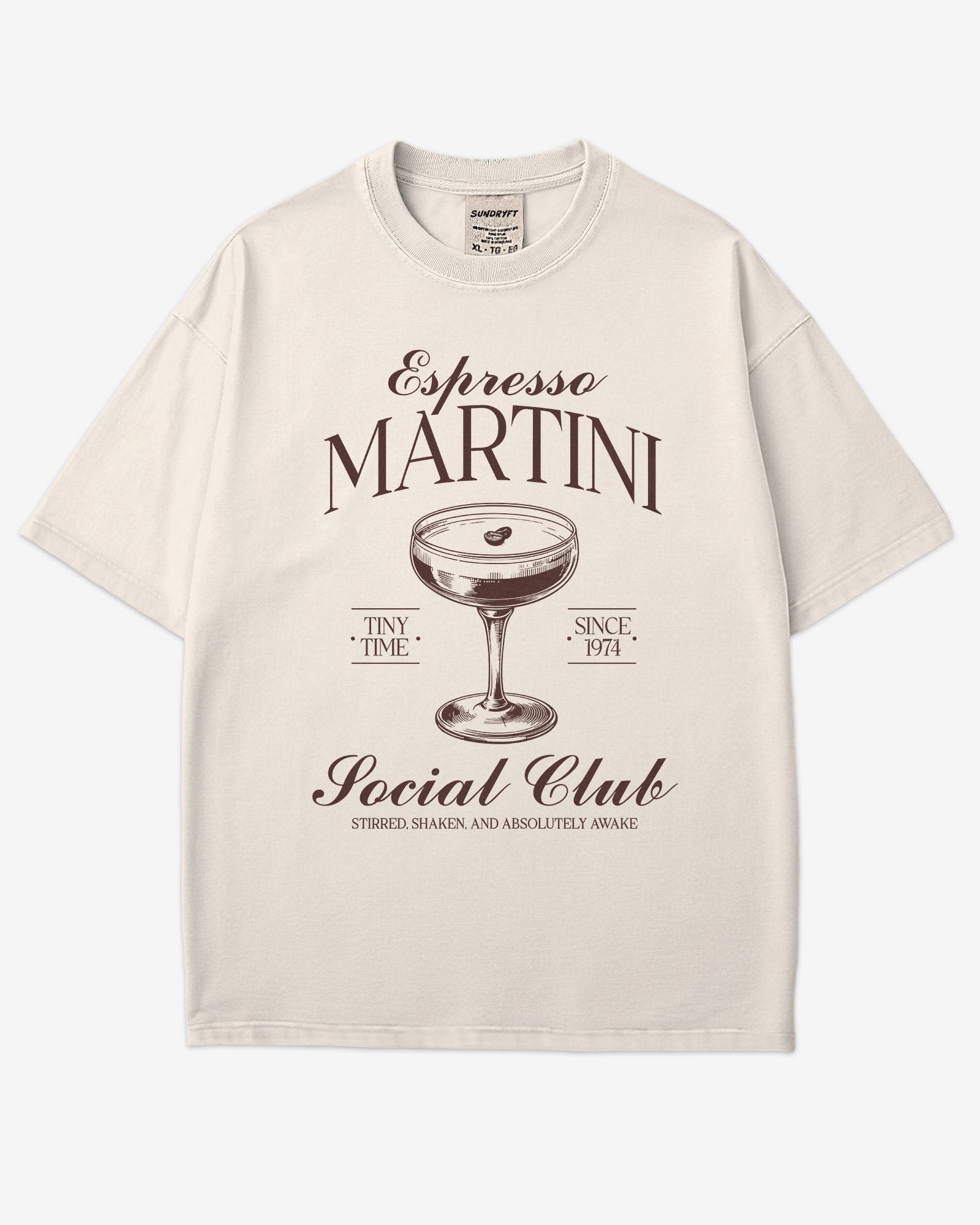 Flat lay ivory 'Espresso Martini Social Club – Stirred, Shaken, and Awake' shirt with a retro graphic of an espresso martini glass.