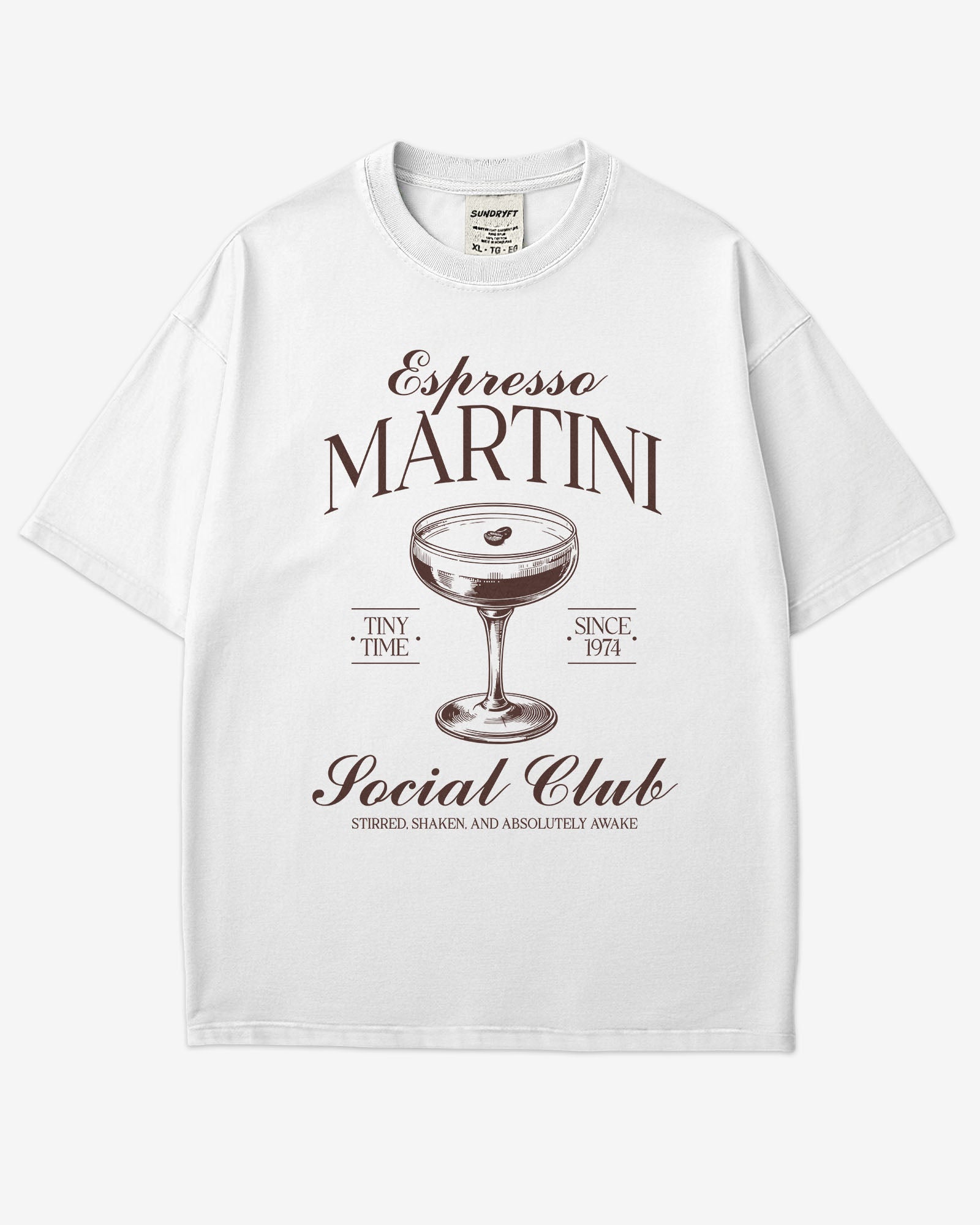 Flat lay white 'Espresso Martini Social Club – Stirred, Shaken, and Awake' shirt with a retro graphic of an espresso martini glass.