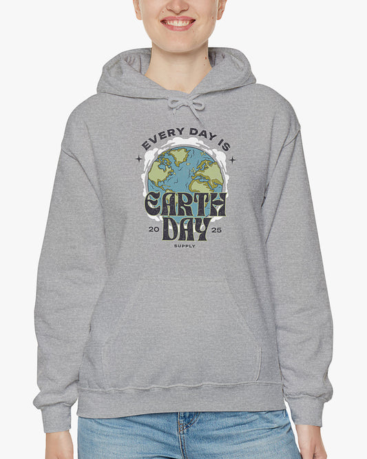 Woman wearing sport gray 'Every Day Is Earth Day 2025' hoodie with retro earth globe graphic