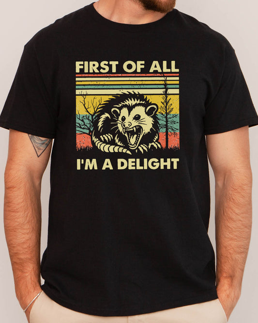 Man wearing retro opossum graphic shirt in black color with the funny quote "first of all, I'm a delight"