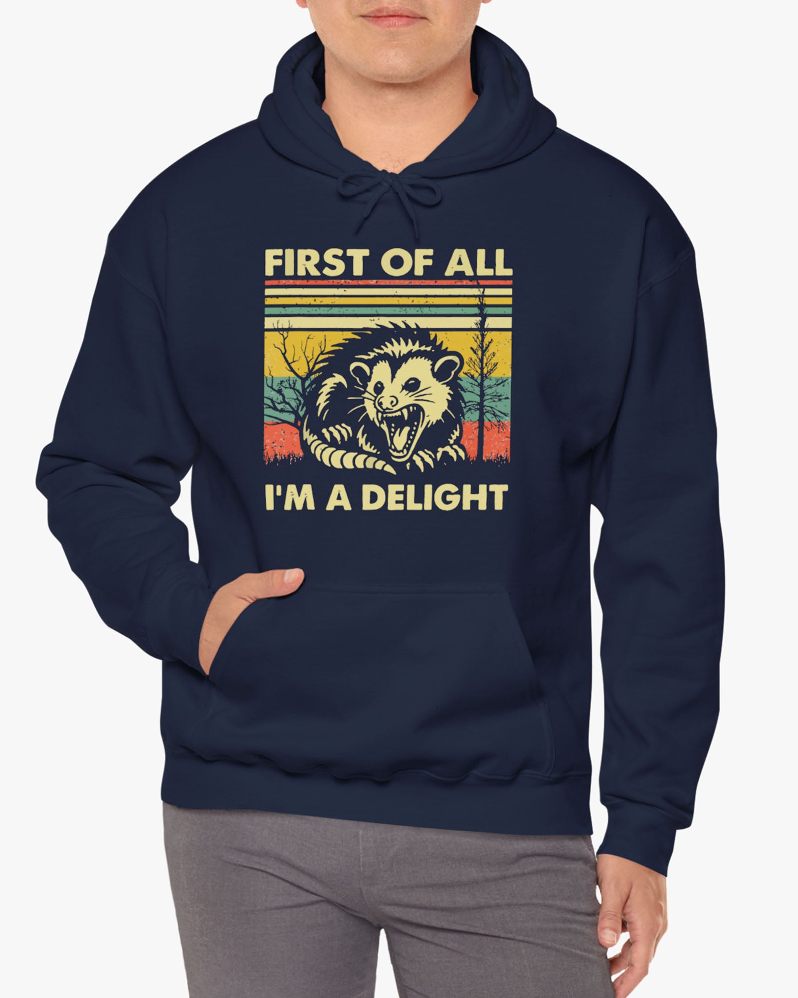 Man wearing a 'First of All I'm A Delight' hoodie in black, featuring a retro western graphic design and unisex fit.