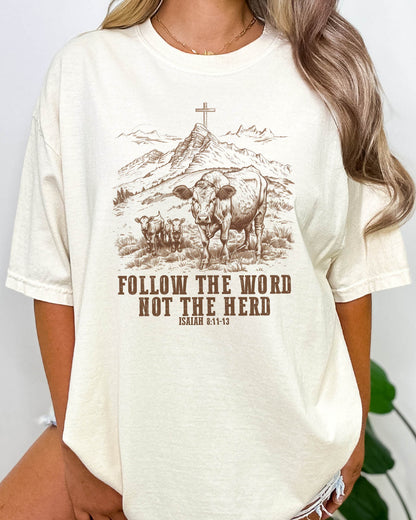 Woman wearing natural beige Christian graphic shirt with Bible verse quote 'Follow the Word, Not the Herd.