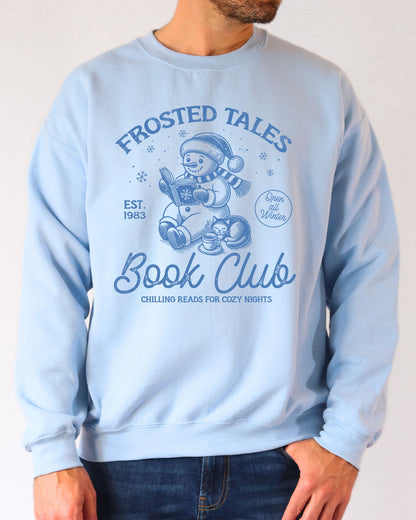 Model wearing light blue color sweatshirt with 'Frosted Tales Book Club' graphic design