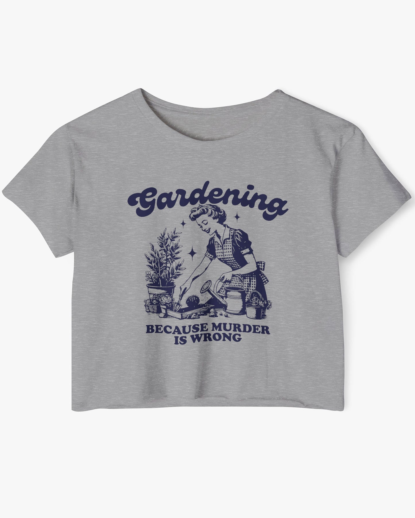 Flat-lay of a dark heather crop top featuring a funny retro-style graphic of a housewife gardening with the text ‘Gardening, Because Murder Is Wrong’.