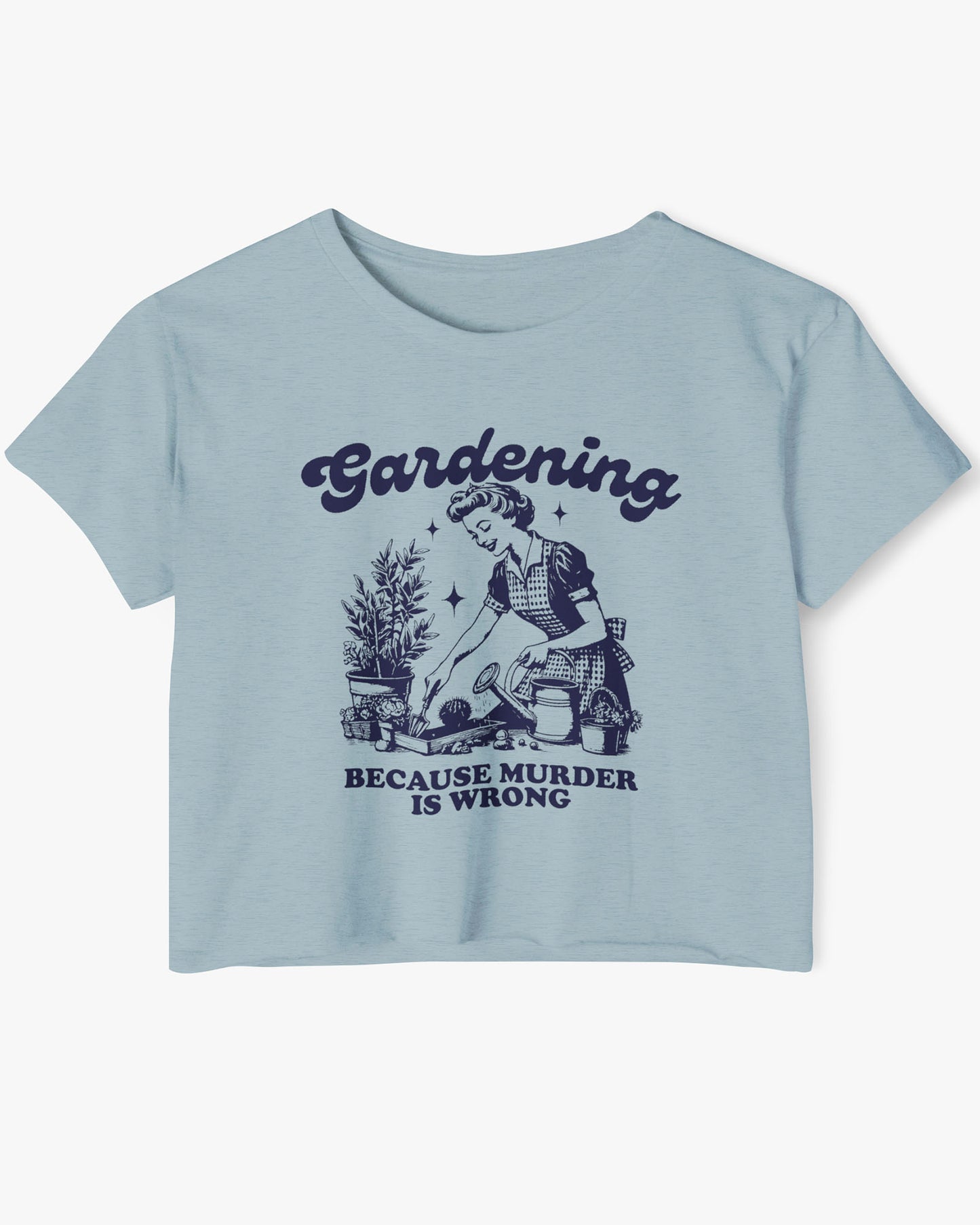 Flat-lay of a stonewash denim crop top featuring a funny retro-style graphic of a housewife gardening with the text ‘Gardening, Because Murder Is Wrong’.