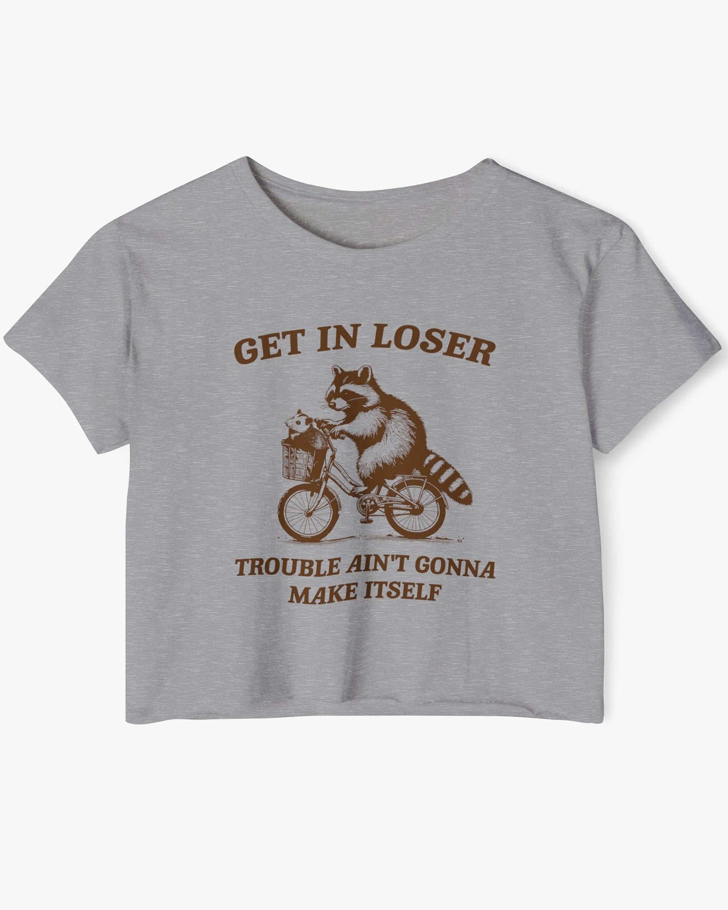 Flat lay dark heather 'Get In Loser, Trouble Ain't Gonna Make Itself' crop top featuring a funny retro raccoon riding a bicycle.