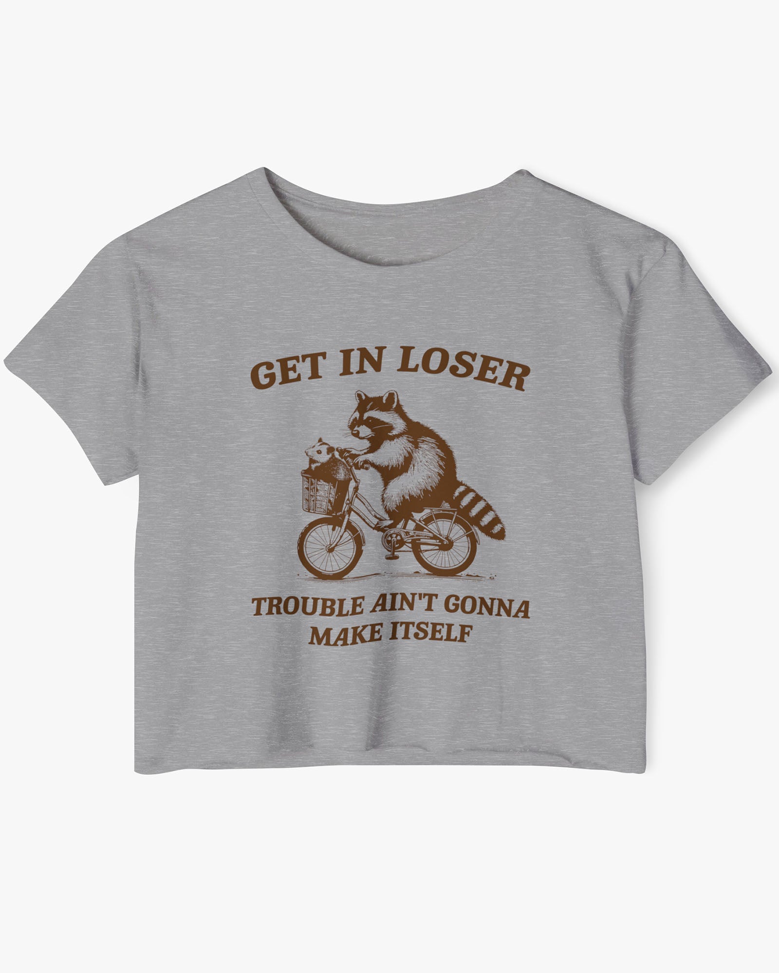Flat lay dark heather 'Get In Loser, Trouble Ain't Gonna Make Itself' crop top featuring a funny retro raccoon riding a bicycle.