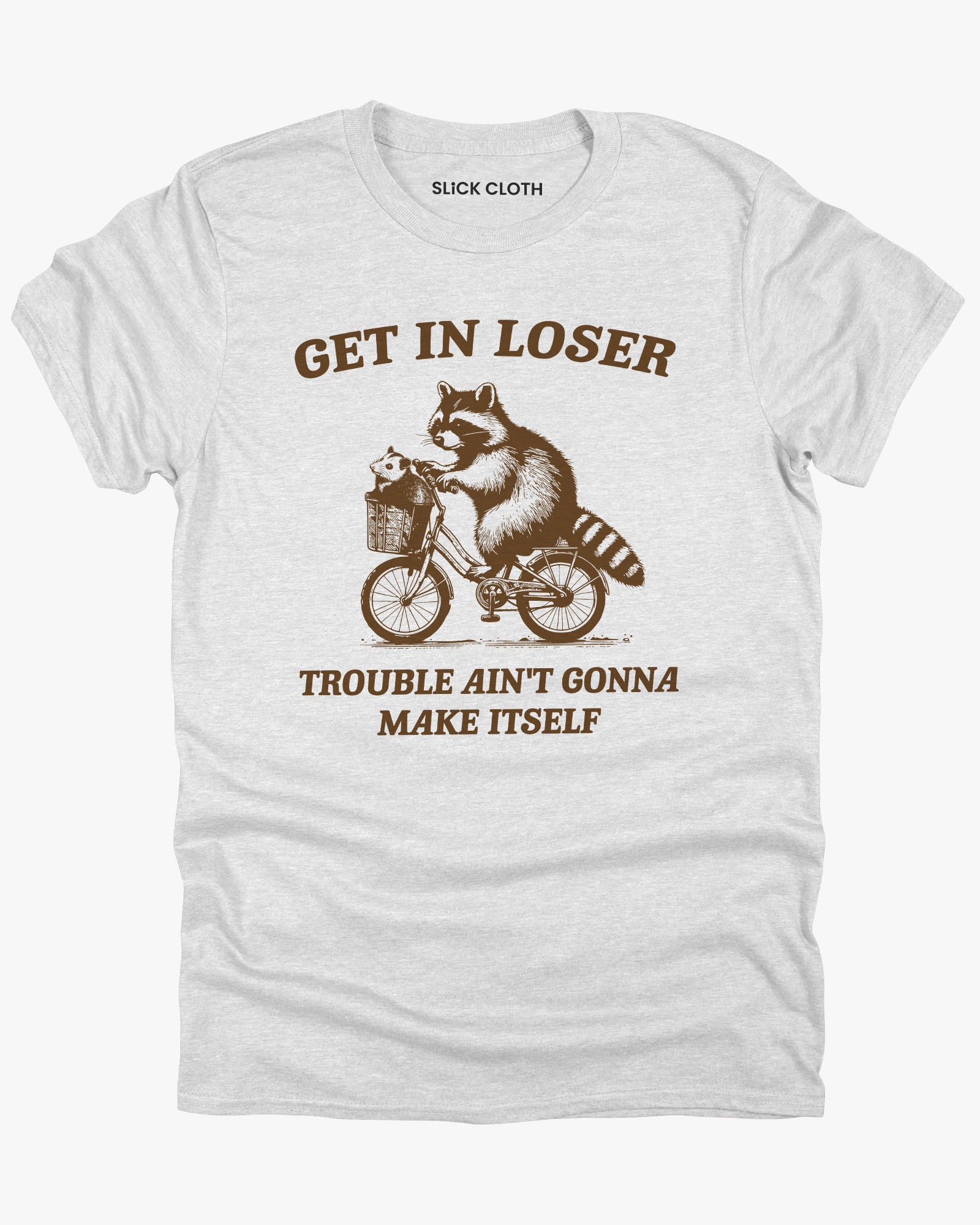 Flat lay ash gray 'Get In Loser, Trouble Ain't Gonna Make Itself' tee featuring a funny retro raccoon riding a bicycle graphic.