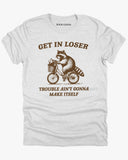 Flat lay ash gray 'Get In Loser, Trouble Ain't Gonna Make Itself' tee featuring a funny retro raccoon riding a bicycle graphic.