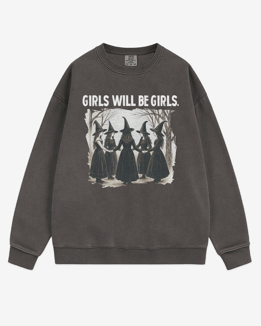 Flat lay pepper 'Girls Will Be Girls' sweatshirt with retro graphic of witches holding hands in a Halloween ritual.